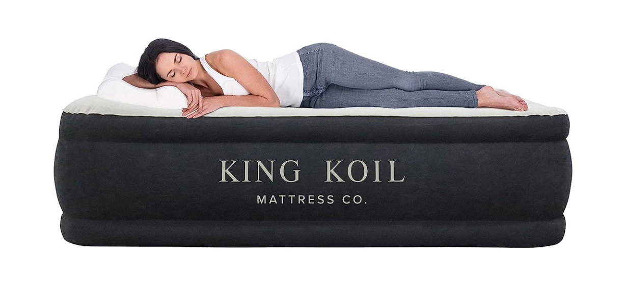 Person sleeping on King Koil Luxury California Air Mattress on white background