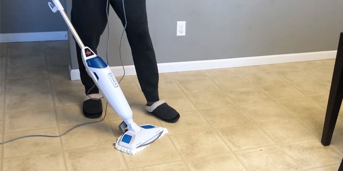Person using Bissell PowerFresh Steam Mop to clean hard flooring