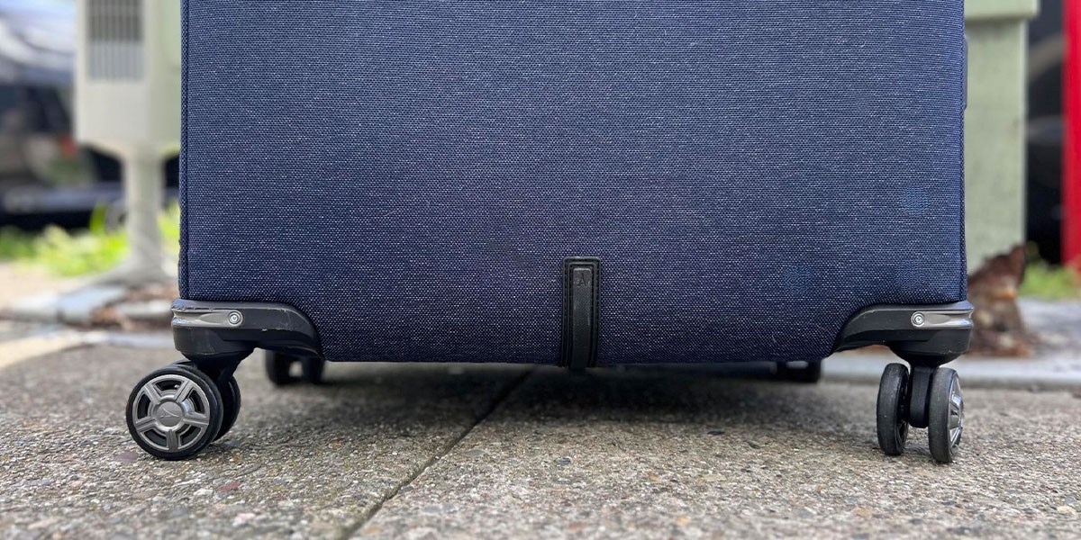 Image of Travelpro Platinum Elite Check-In Spinner wheels on concrete Image of Travelpro Platinum Elite Check-In Spinner wheels on concrete