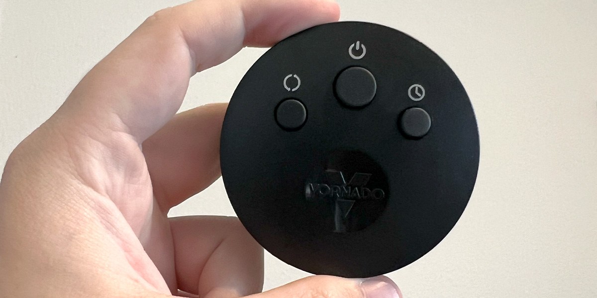 View of  Vornado OSC84 Tower Fan remote with hand View of  Vornado OSC84 Tower Fan remote with hand