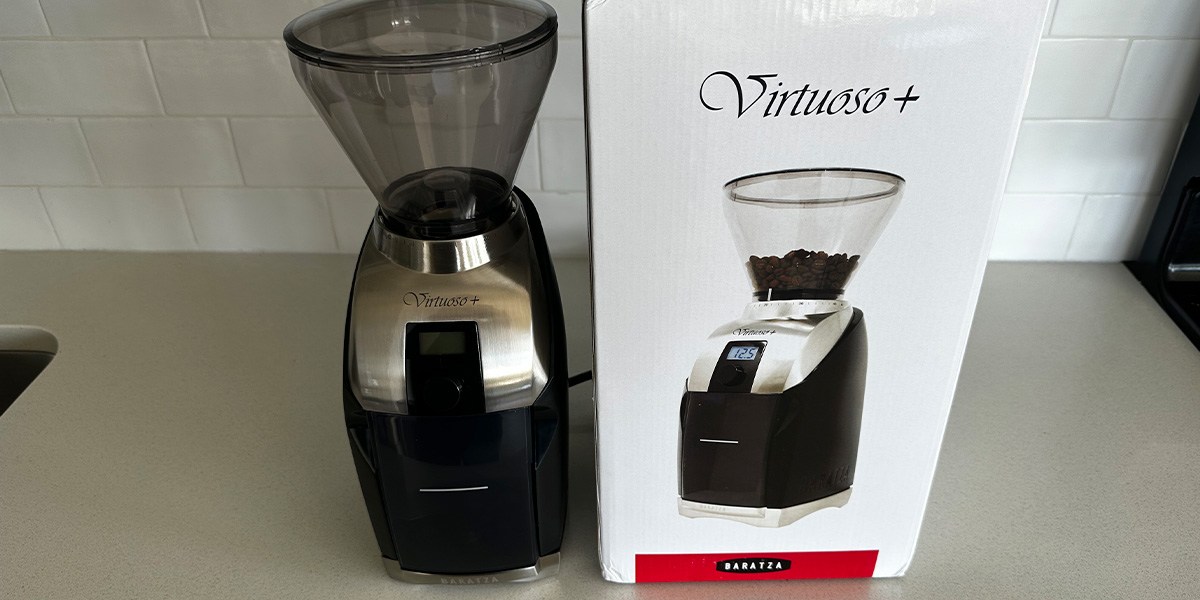 Coffee grinder next to product packaging