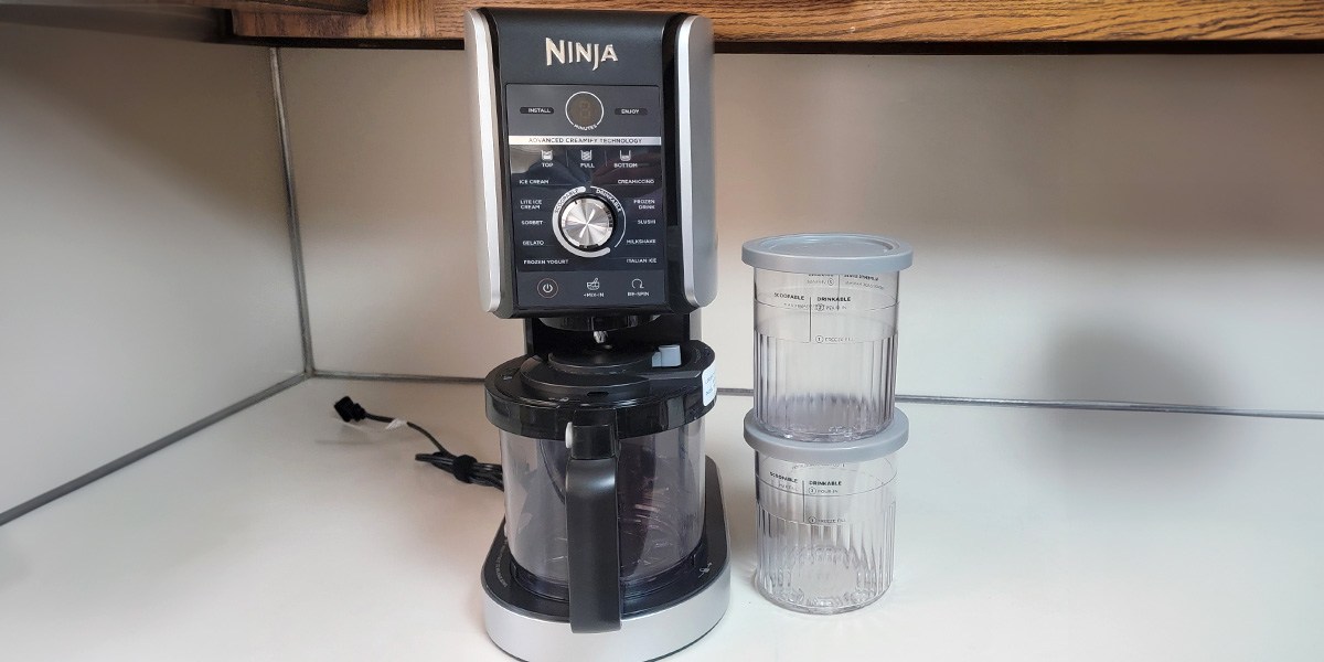 Front view of Ninja Creami Deluxe and accessories on kitchen counter