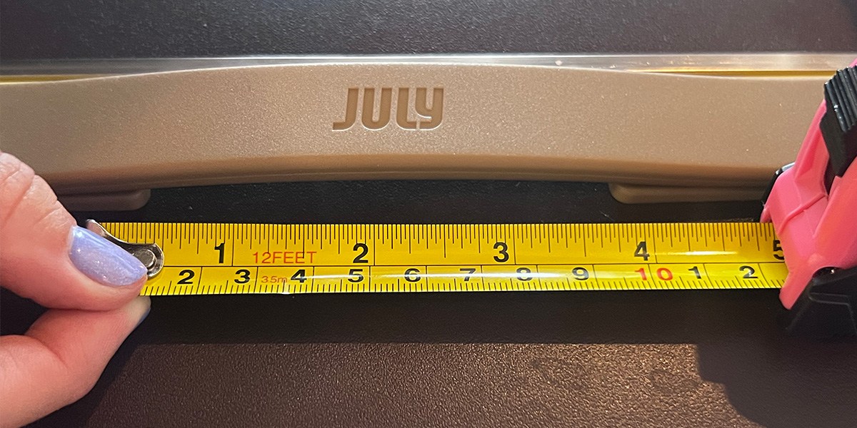 July Checked Trunk with person holding measuring tape in front July Checked Trunk with person holding measuring tape in front