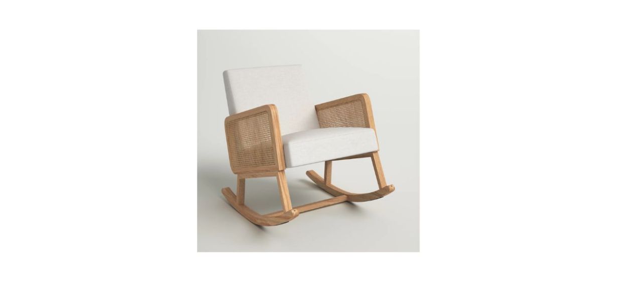 a white plush rocking chair with rattan arms and wooden legs
