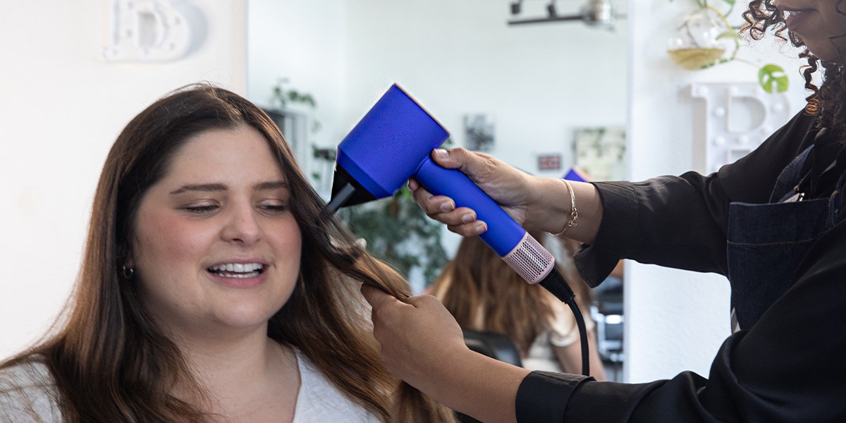 Person having hair styled with Dyson Supersonic Hair Dryer