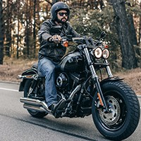 a man riding a motorcycle wearing a motorcycle glasses