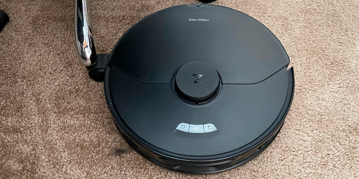 Robotic vacuum cleaning beige carpet