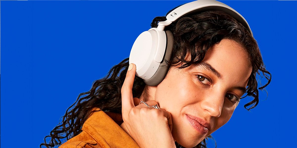 Person wearing Sennheiser Accentum Plus on blue background