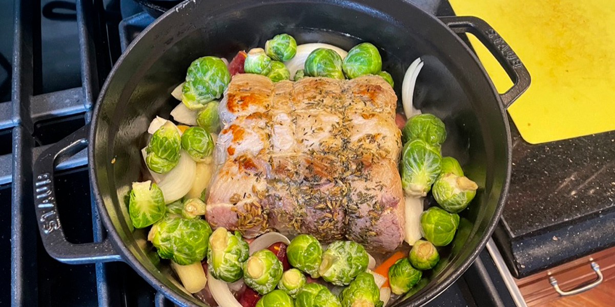 Staub Cast Iron Dutch Oven on stovetop with food inside