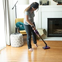 a person cleaning with a vacuum